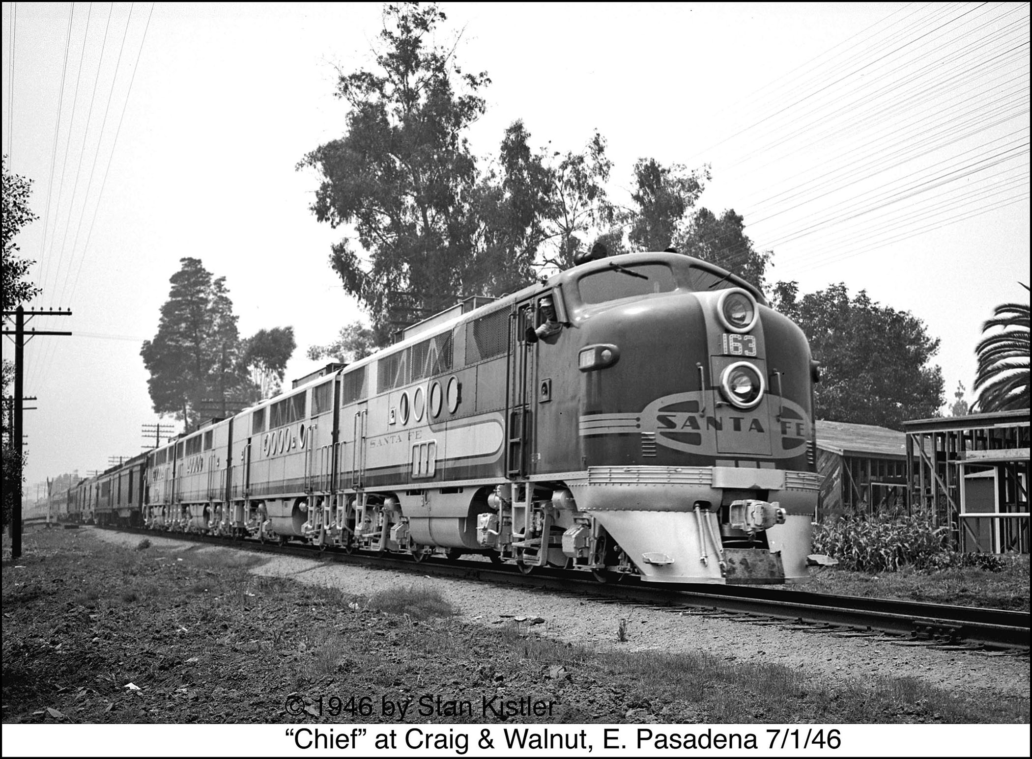 The engineer waves at the camera as the Chief speeds Eastbound through Pasadena on July 1, 1946.